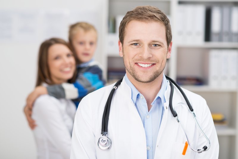 Doctor with patients in background
